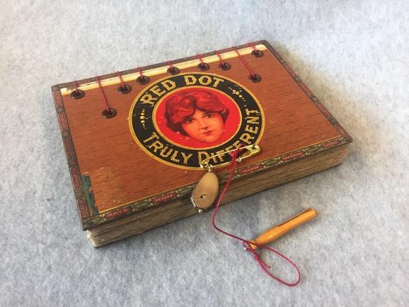 Susan Koen; “Truly Different”; Coptic Stitch Book with Cigar Box Covers andFound Object Closure; 9” x 5” x 1.5”; Coptic Project Involving Found Object Covers; Fall 2018